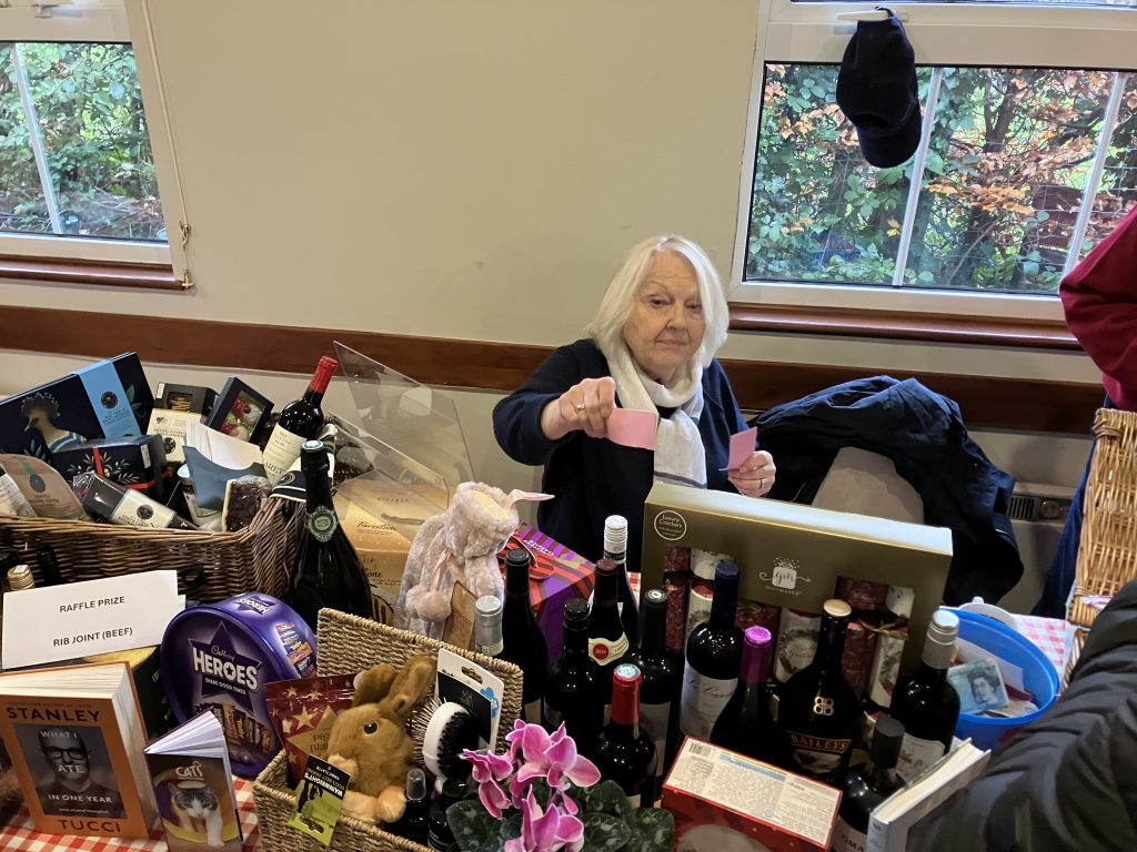 Volunteer committee member selling raffle tickets at the Christmas Fair 2025