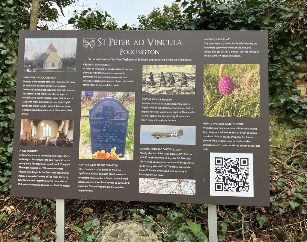 A sign with information about the village church and hamlet of Folkington in East Sussex